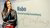 Daniella next to the Risbo sign in the office at Rotterdam